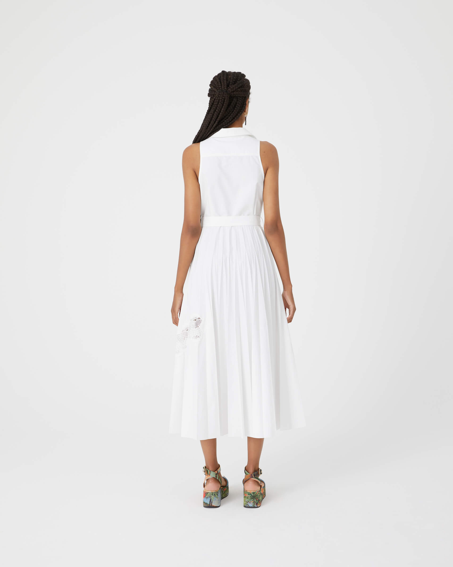 long pleated white dress with lace inserts